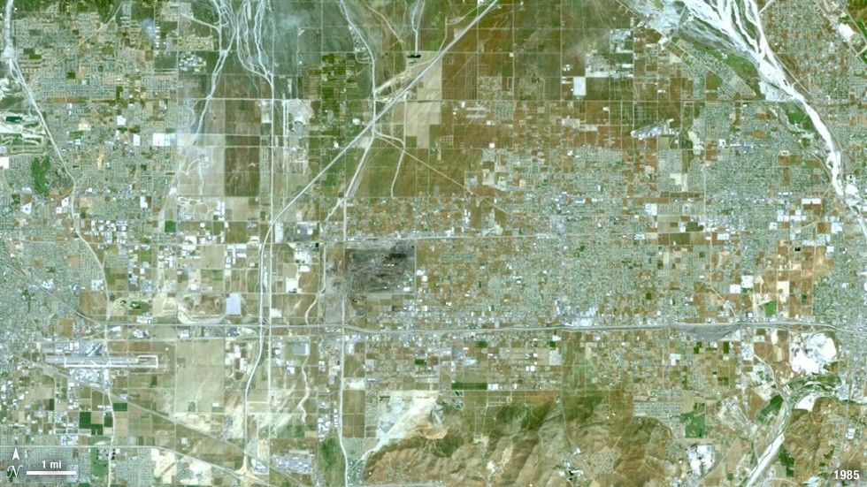This natural color Landsat 5 image shows the city of Ontario, California, from above in the year 1985. Vegetation is green and brown and urban structures are bright white and gray. There is a large dry riverbed in the northeast corner that is also bright white, but its nonlinear appearance sets it apart visually.