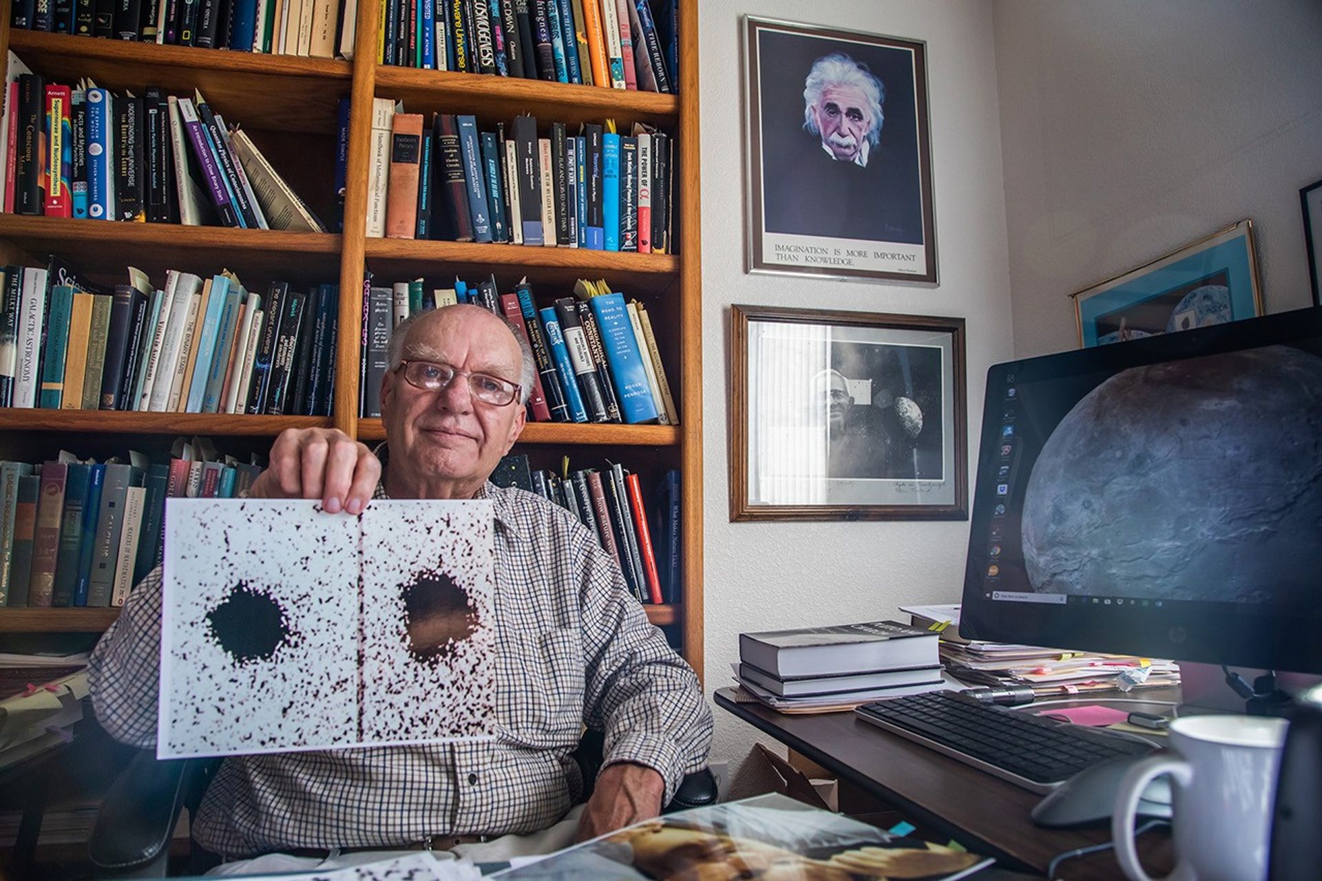 James Christy in 2018 holding an old image of Charon.